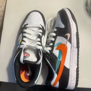 Nike Black and White Shoes with Vibrant Orange Swoosh